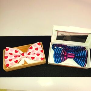 2 pre-tied bow ties, 1 with red and pink ♥️'s. The other is multi color striped.